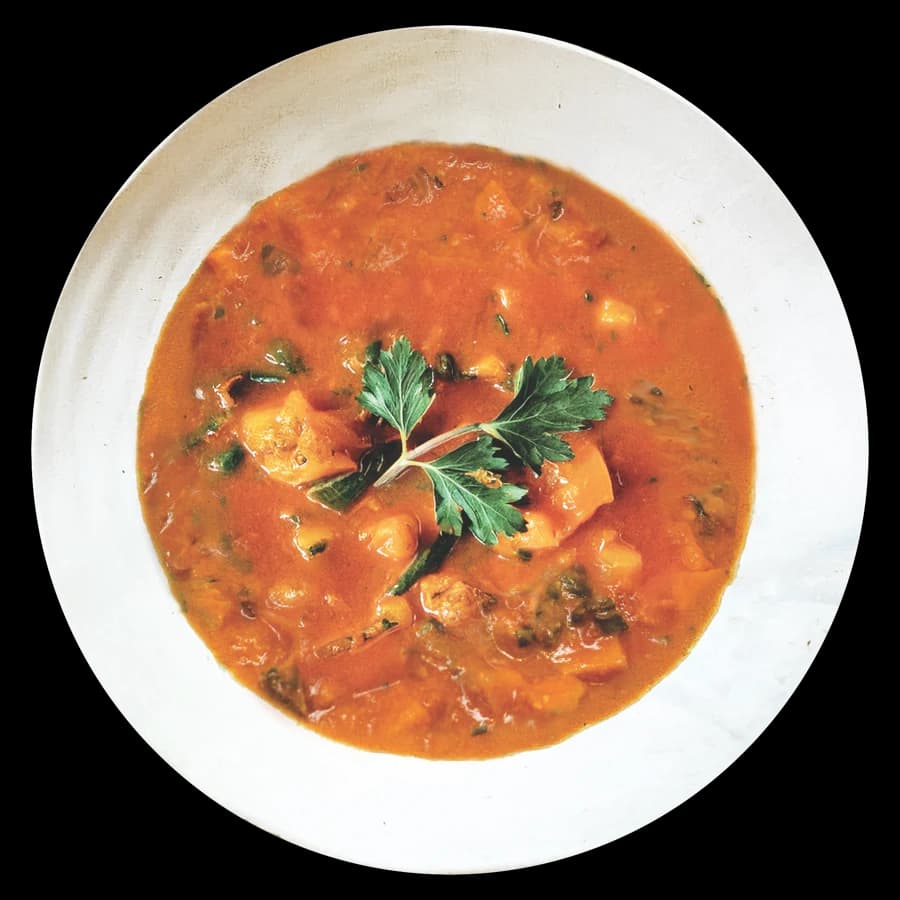 Bowl of West African peanut stew with chickpeas and vegetables